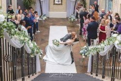 nailcote hall birmingham wedding photography bride groom doing the dip walking back down the ceremony room